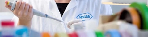 A scientist from Roche with an ampoule